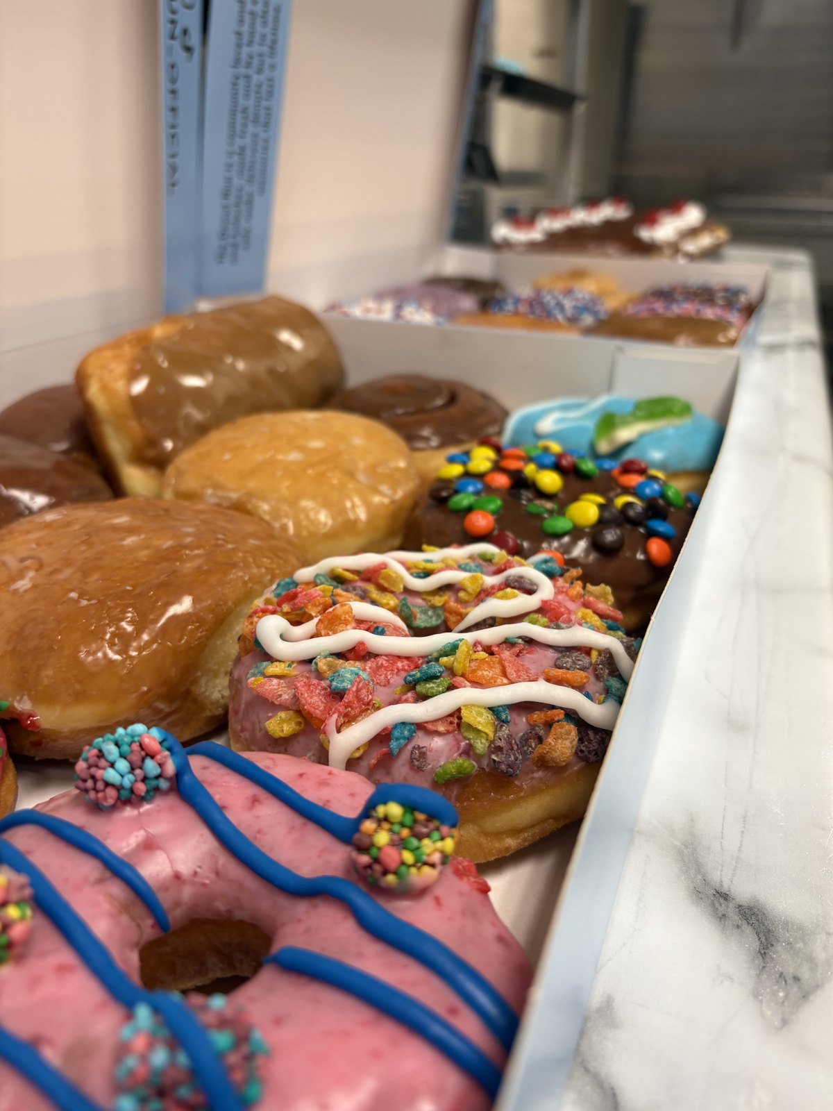 The Donut Run case, assorted donuts boxed and ready