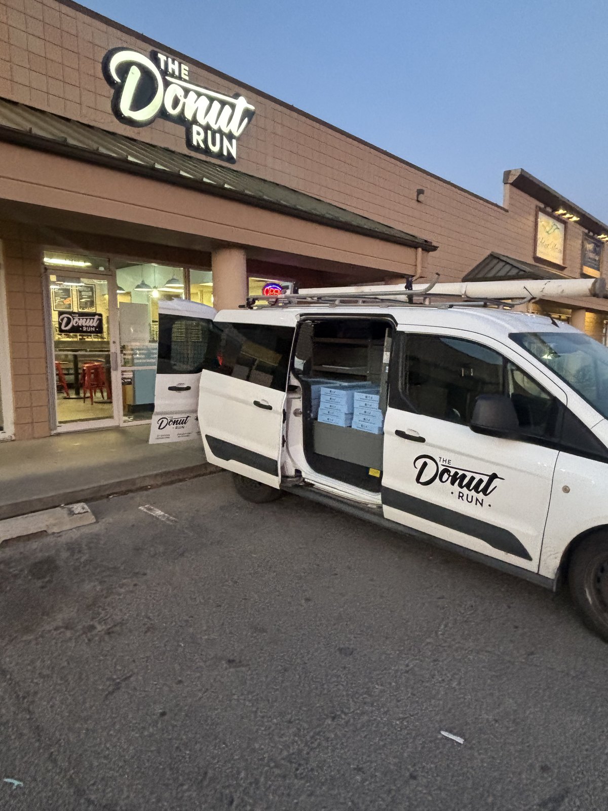 The Donut Run van loaded with boxes outside the shop before opening