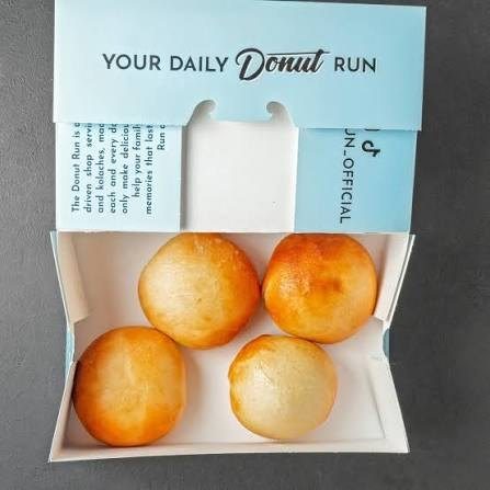 A branded box of donuts from The Donut Run, Utah