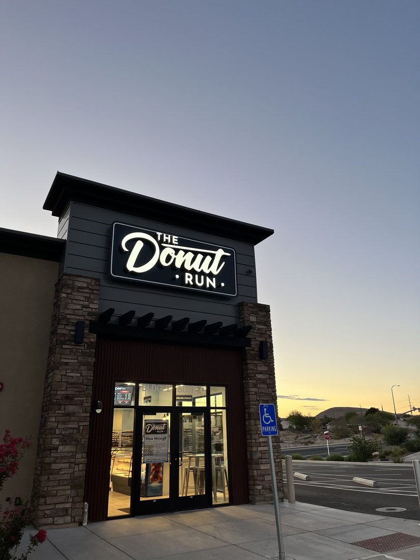 The Donut Run donut shop on Brigham Road in St. George, Utah, lit against the dawn sky